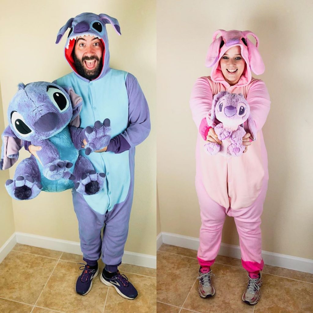 Katie and Spencer wearing Stitch and Angel onsies holding plushies