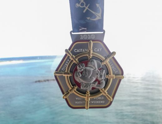 2020 Run Disney Castaway Cay Challenge Medal featuring Captain Minnie Mouse and ships wheel in front of blue water backgroudn